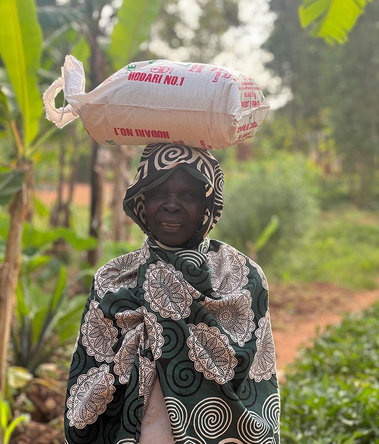 Elderly Woman With A Package Of Rice On Her Head 2